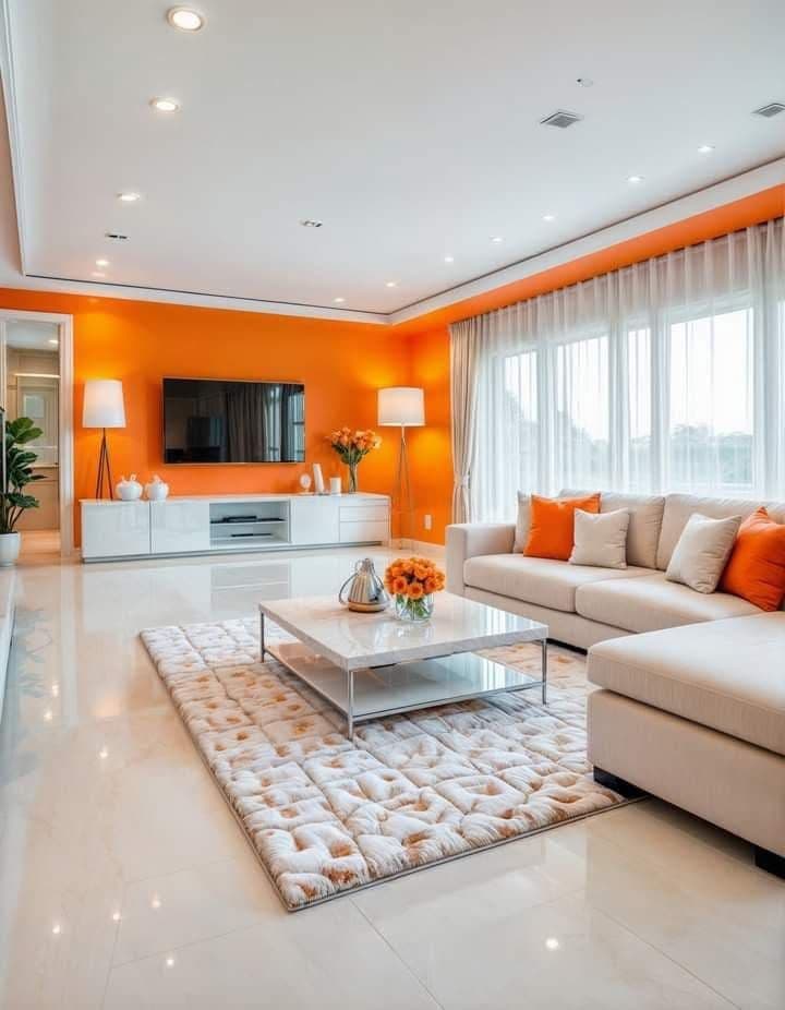 Salon moderne aux accents orange, assises graphiques et grand tapis