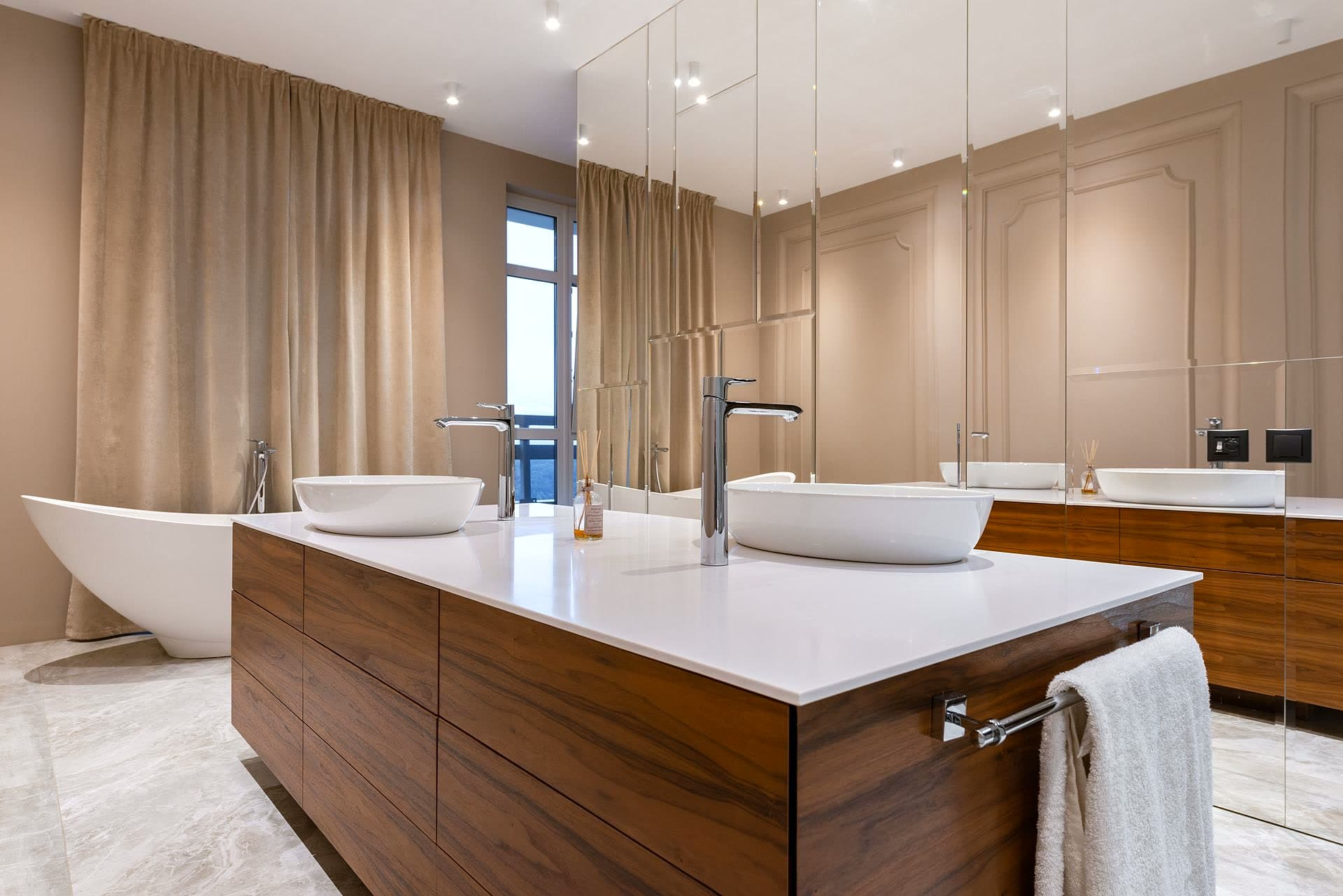 Salle d'eau d'un appartement en gestion, faïence claire et rangements discrets